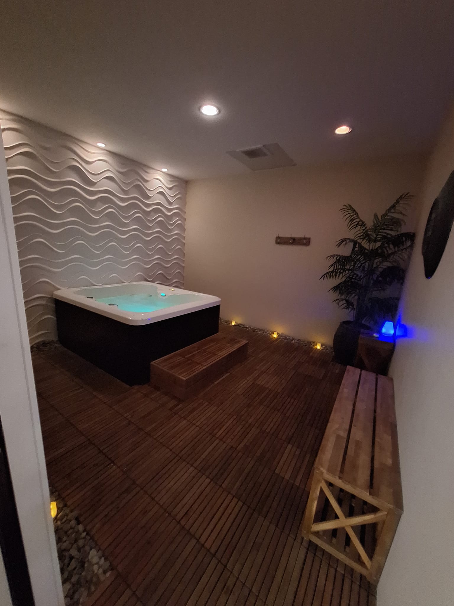 Relaxing spa room with hot tub.