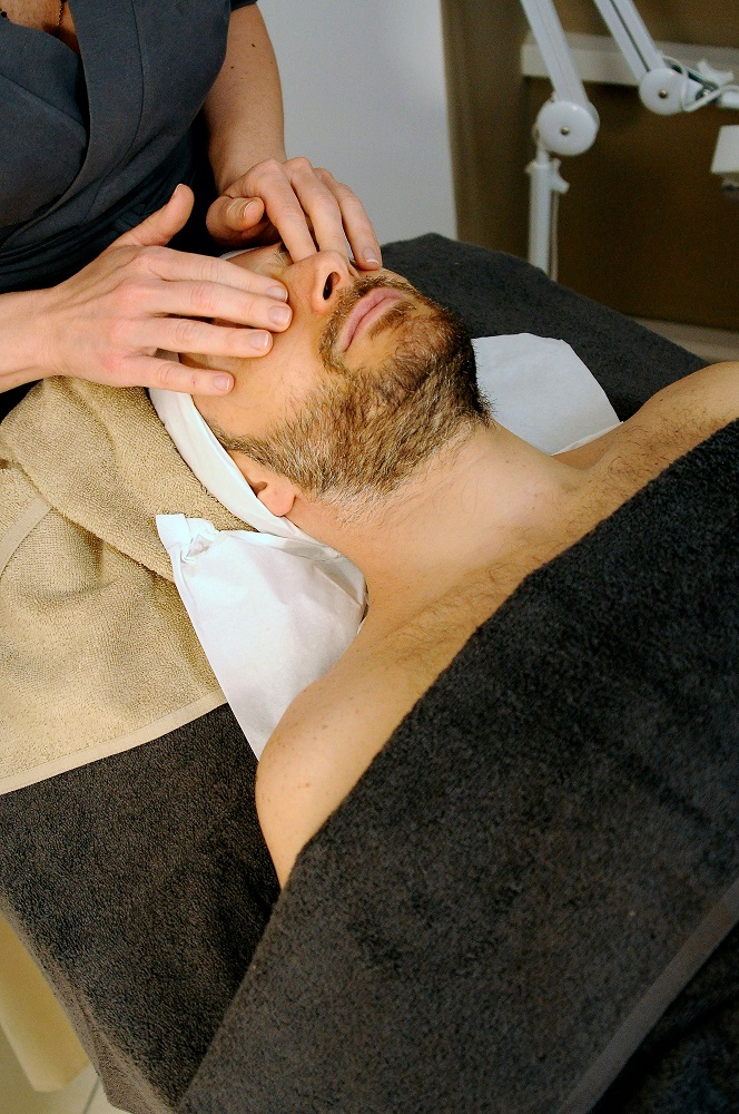 Man receiving a facial treatment.