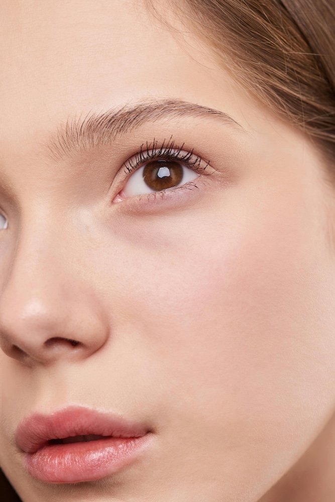 Close up young attractive woman's face with flawless skin.